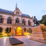 Adelaide, Australia - January 1, 2016: The statue of Sir Walter Watson Hughes (1803–1887), one of the founders of The University of Adelaide, in front of the Mitchell Building, which is the first building erected for the university, on the North Terrace.